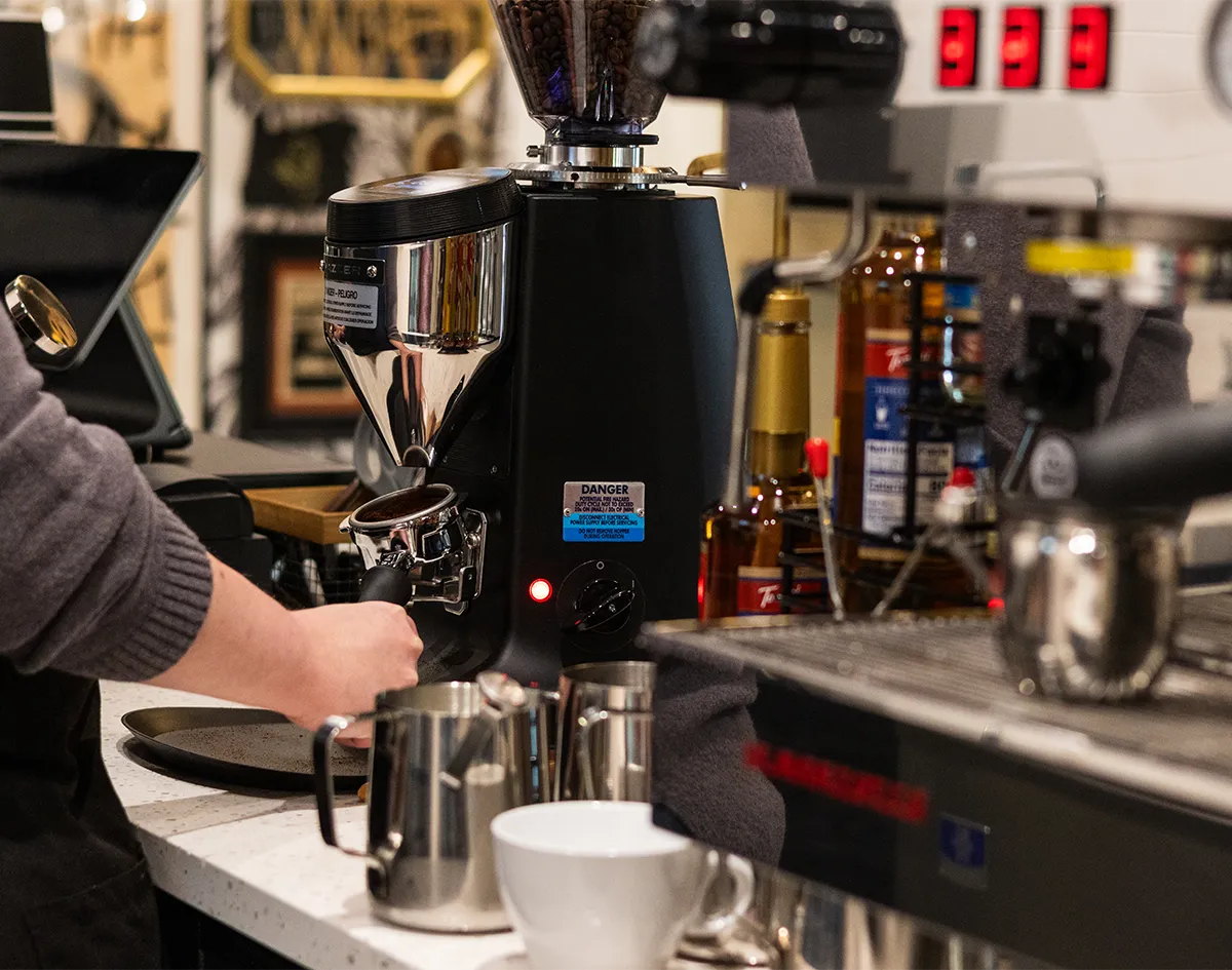 barista grinding coffee for espresso